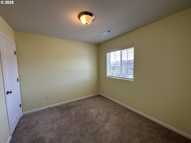 unfurnished room with carpet flooring, a textured ceiling, and baseboards