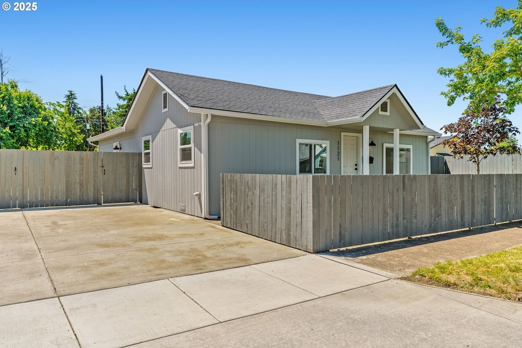 1121 D St, Springfield, OR 97477 - view of side of home with driveway and a shingled roof