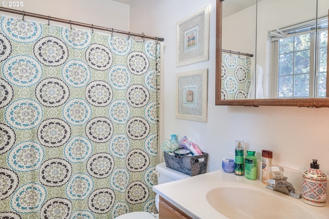 bathroom featuring vanity and toilet