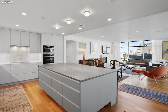 kitchen featuring light wood-style floors, cooktop, and modern cabinets