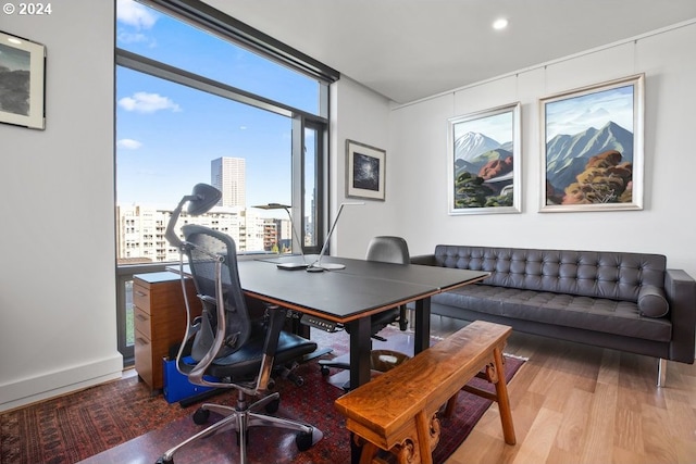 home office with a view of city, recessed lighting, and wood finished floors
