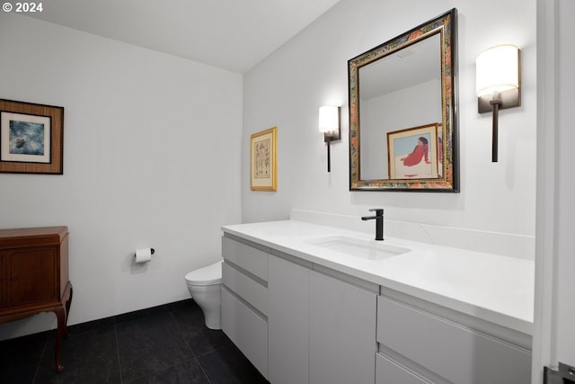 bathroom featuring toilet, baseboards, tile patterned flooring, and vanity