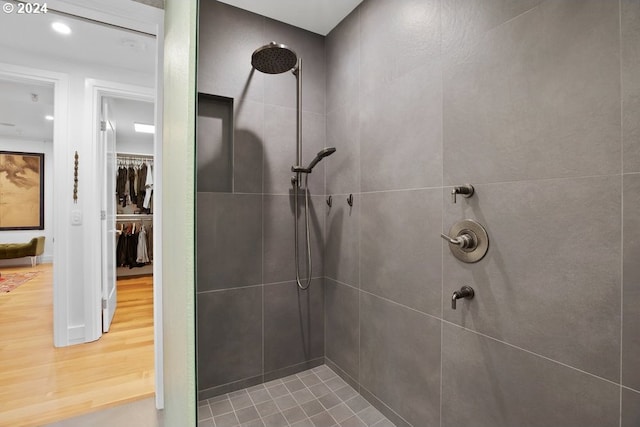 bathroom featuring a tile shower and wood finished floors