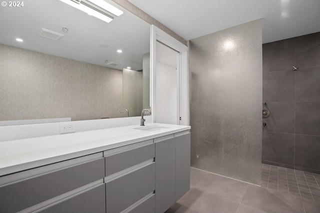 bathroom with recessed lighting, walk in shower, tile patterned flooring, and vanity