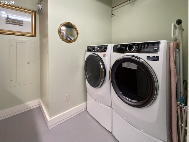 clothes washing area with baseboards, laundry area, and washing machine and dryer