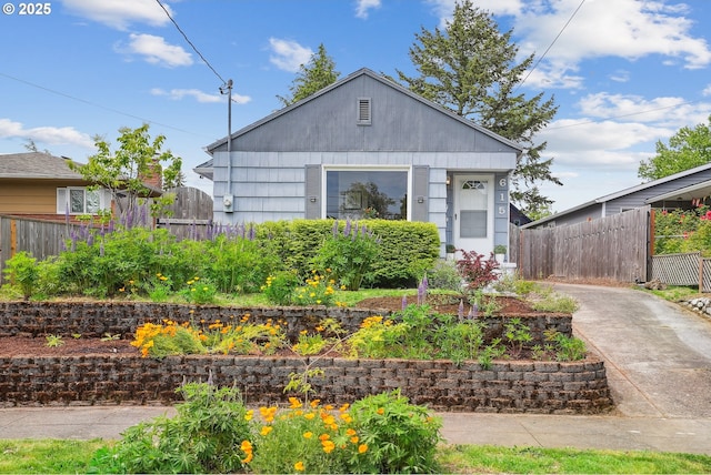 view of front of home featuring fence