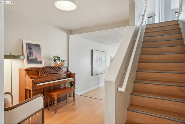 stairs with wood finished floors and baseboards