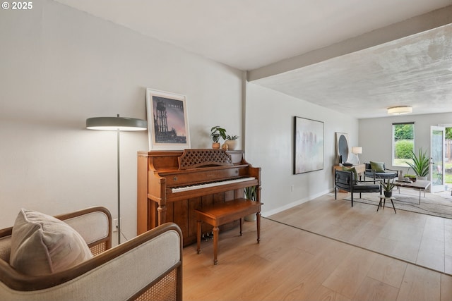 sitting room with light wood-type flooring and baseboards