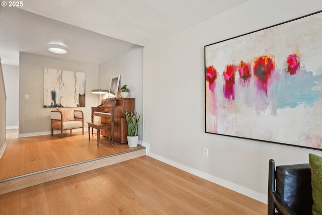 living area with wood finished floors and baseboards