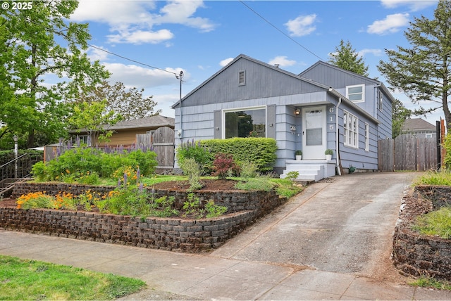 bungalow with driveway and fence