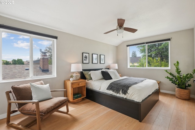 bedroom with light wood finished floors, baseboards, ceiling fan, and lofted ceiling