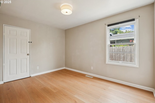 unfurnished room featuring light wood-type flooring and baseboards
