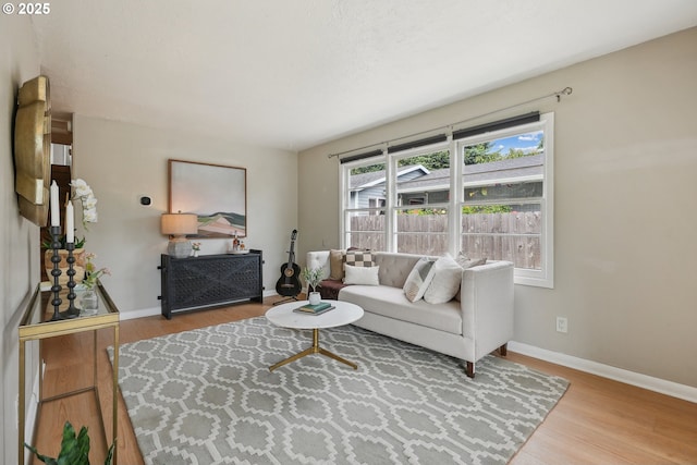 living area with wood finished floors and baseboards