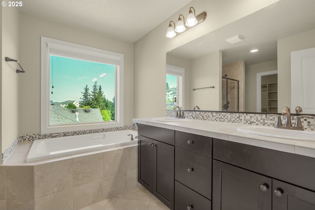 bathroom featuring vanity, toilet, tile patterned floors,  shower combination, and backsplash