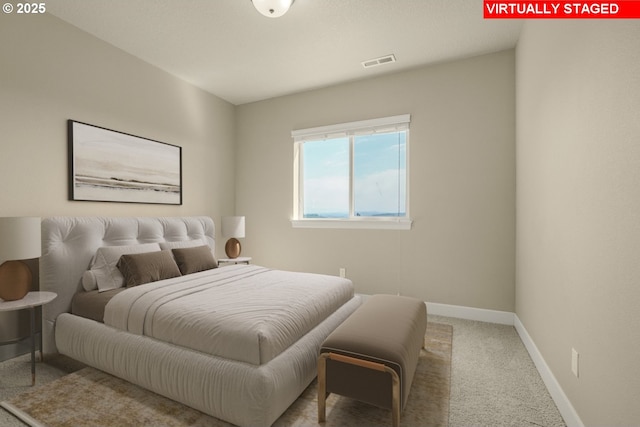 carpeted bedroom with baseboards and visible vents