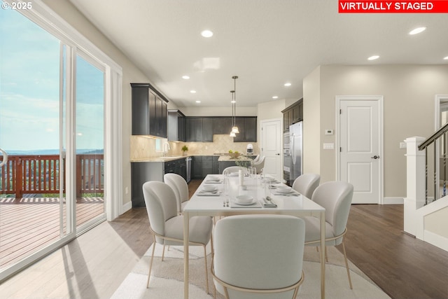 dining space with recessed lighting, baseboards, and wood finished floors