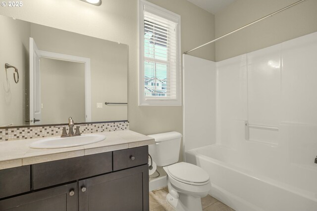 full bathroom with bathtub / shower combination, vanity, toilet, tile patterned floors, and tasteful backsplash