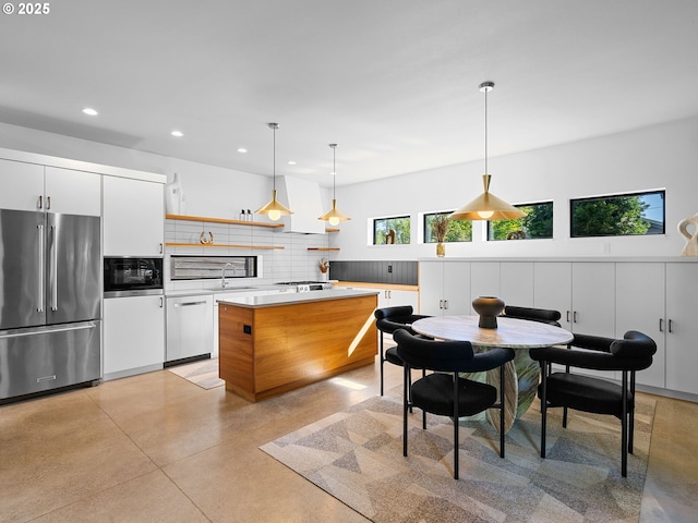 kitchen with appliances with stainless steel finishes, concrete flooring, recessed lighting, decorative backsplash, and white cabinets