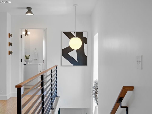 stairs featuring wood finished floors and baseboards