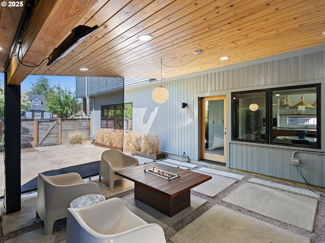 view of patio / terrace featuring an outdoor fire pit, fence, and a gate