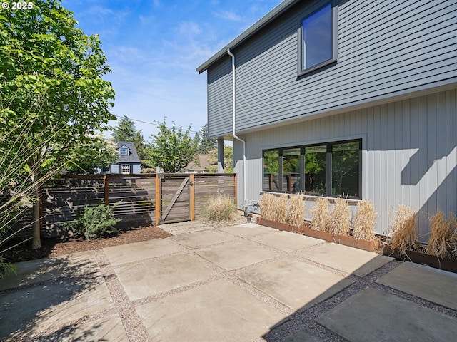 view of patio with a gate and fence