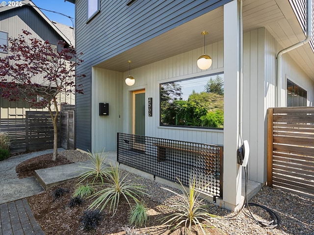doorway to property featuring fence