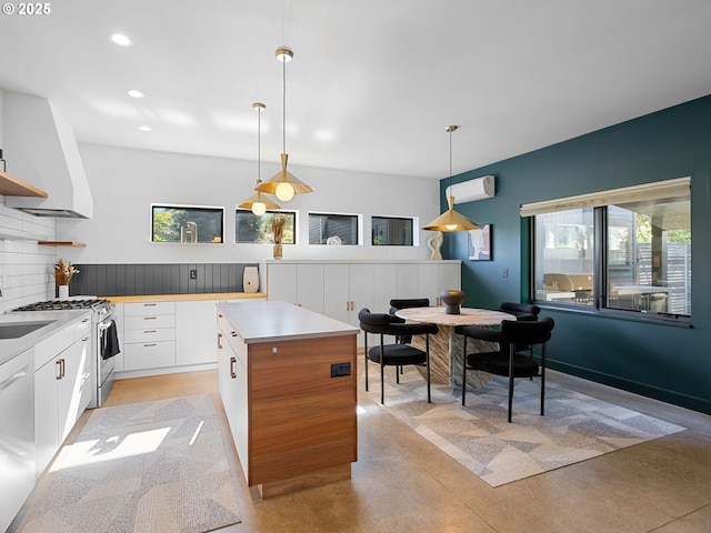 kitchen featuring white range with gas stovetop, finished concrete floors, white cabinetry, open shelves, and pendant lighting
