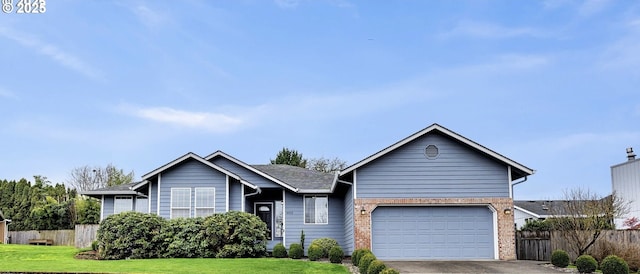 single story home featuring an attached garage, concrete driveway, a front lawn, and fence