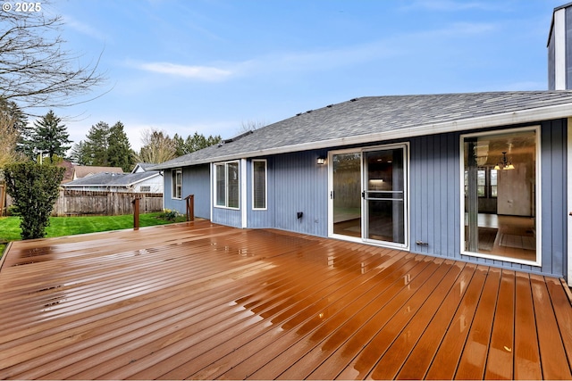 wooden deck featuring a yard and fence