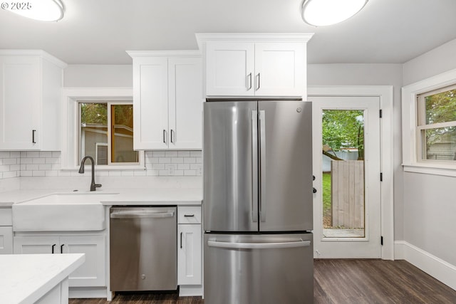 9605 N Hodge Ave, Portland, OR 97203 - kitchen with appliances with stainless steel finishes, a sink, decorative backsplash, and white cabinetry