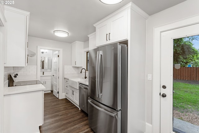 9605 N Hodge Ave, Portland, OR 97203 - kitchen with stainless steel appliances, tasteful backsplash, light countertops, white cabinetry, and a sink