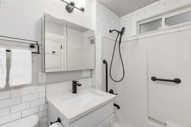 9605 N Hodge Ave, Portland, OR 97203 - full bathroom with tile walls, vanity, toilet, and shower / bath combination