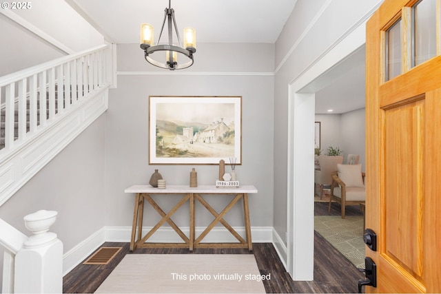 9605 N Hodge Ave, Portland, OR 97203 - foyer featuring dark wood-style flooring, a chandelier, and baseboards