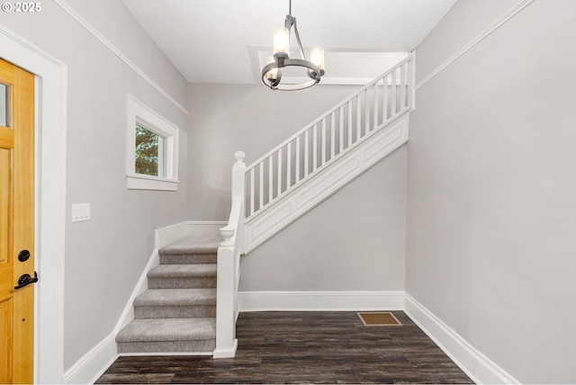 9605 N Hodge Ave, Portland, OR 97203 - entryway with stairs, a chandelier, wood finished floors, and baseboards