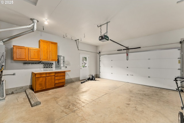 garage featuring electric panel and a garage door opener