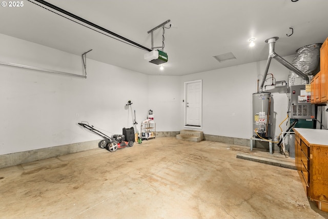 garage with gas water heater and a garage door opener