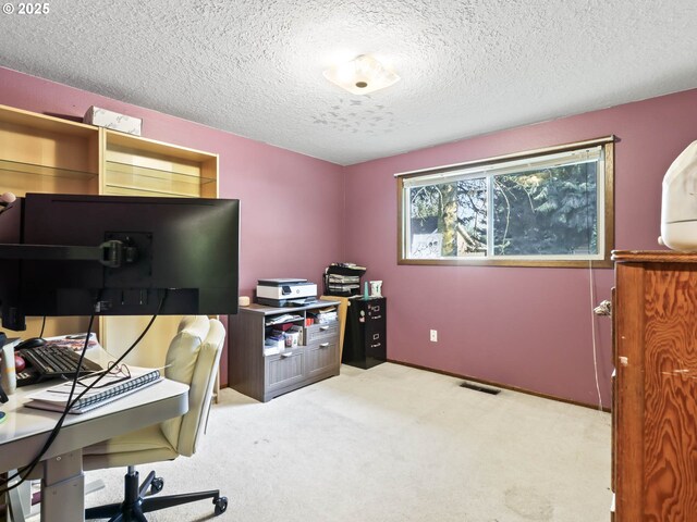 office with a textured ceiling and light carpet