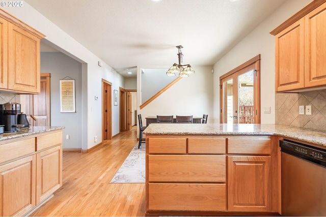 kitchen featuring backsplash, stainless steel dishwasher, light stone countertops, light wood-type flooring, and a peninsula