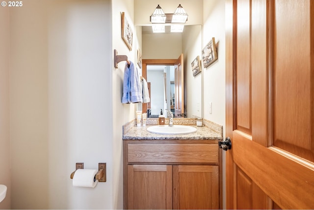 half bathroom with toilet and vanity