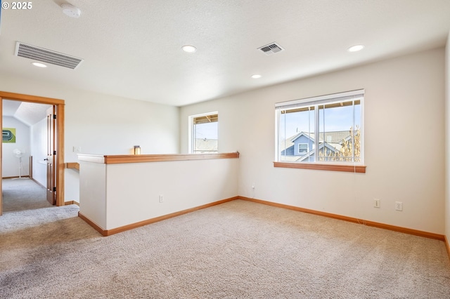 carpeted spare room with recessed lighting, visible vents, and baseboards