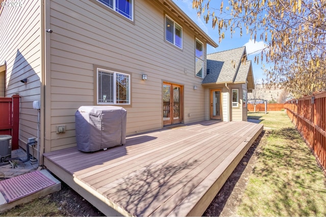 wooden terrace featuring a fenced backyard and a grill