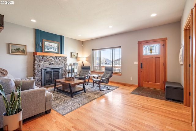 living room with a fireplace, baseboards, wood finished floors, and recessed lighting