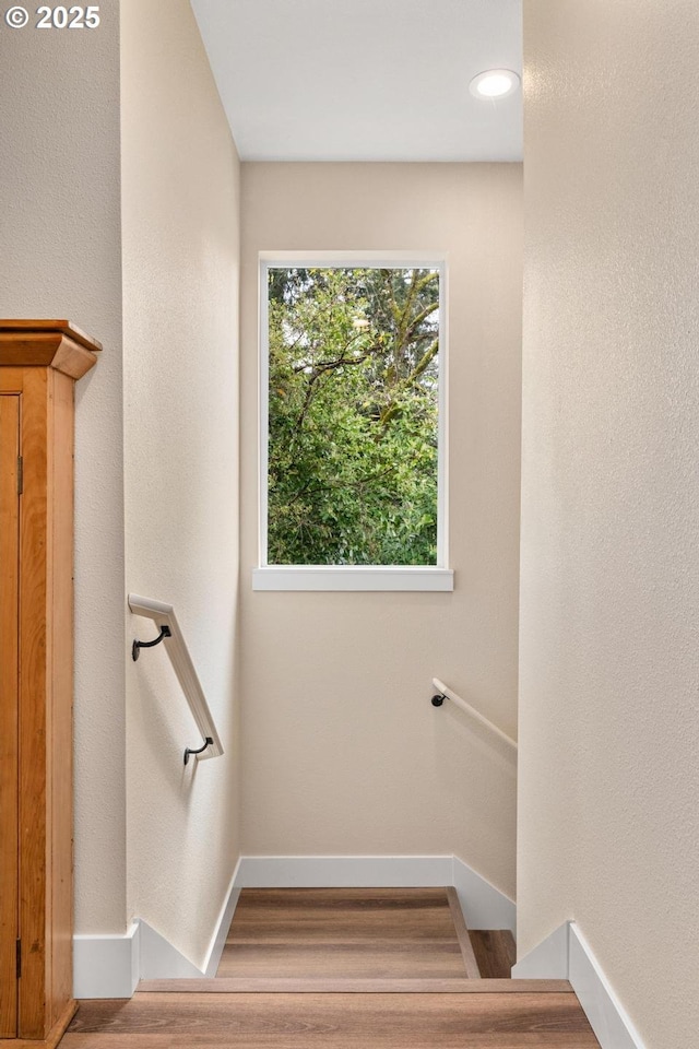 stairs with baseboards and wood finished floors