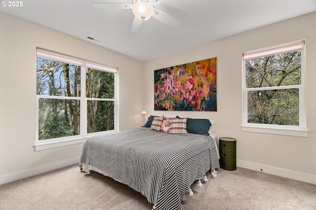 bedroom with carpet flooring, a ceiling fan, baseboards, and visible vents