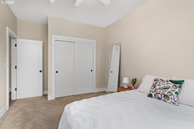 carpeted bedroom featuring baseboards, ceiling fan, and a closet