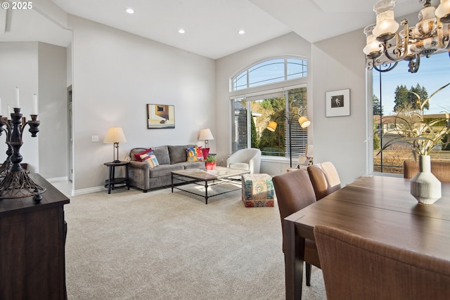 living room with light carpet and an inviting chandelier