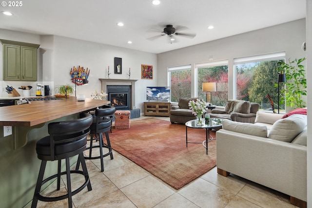 tiled living room with ceiling fan