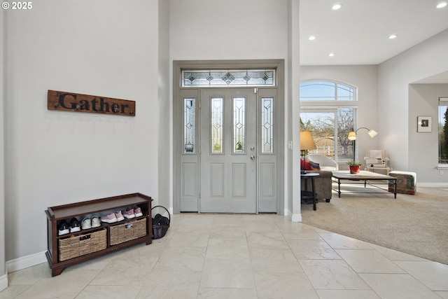 entryway featuring light colored carpet