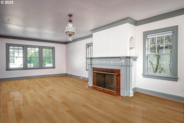 1856 SE Saint Andrews Dr, Portland, OR 97202 - unfurnished living room with wood finished floors, a brick fireplace, baseboards, and ornamental molding