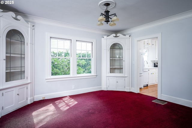1856 SE Saint Andrews Dr, Portland, OR 97202 - unfurnished dining area featuring a chandelier, crown molding, baseboards, and light colored carpet